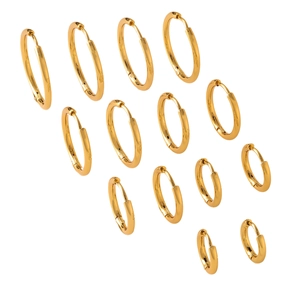 Polished gold hoop earrings set in various sizes arranged on a white background