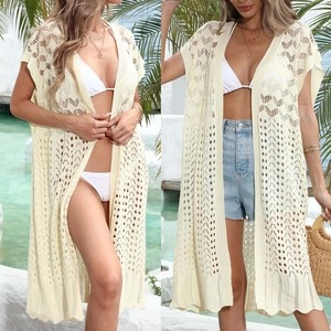 Detailed knit texture and herringbone hollow pattern on a cream beach kimono cover-up
