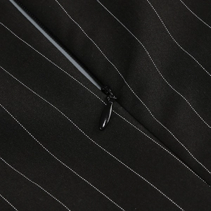 Close-up of black pinstripe fabric detail with a seamless concealed zipper on dress