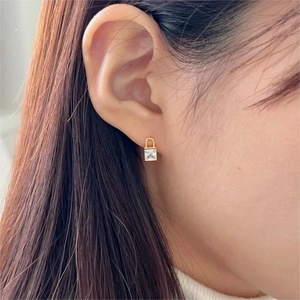 Minimalist gold plated 925 silver lock earrings with square zircon on female model