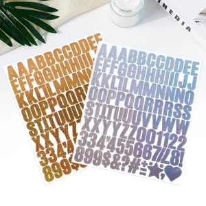 Detail of 1-inch gold glitter and iridescent purple alphabet stickers for scrapbooking