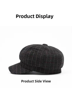 Side view detail of a vintage grey newsboy cap with brown plaid wool pattern