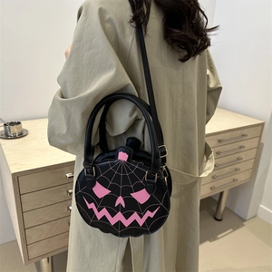 Chic black pumpkin shaped shoulder bag with pink ghost face pattern for Halloween style