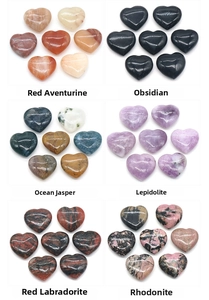Macro display of six natural heart-shaped gemstones including obsidian and rhodonite