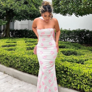 Close-up of the elegant pink floral print on a white strapless bodycon maxi dress