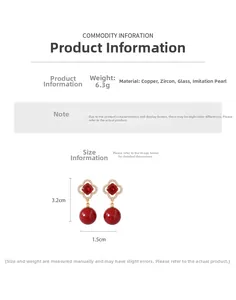 Detail view of flower pendant earrings with red zircon stones and imitation pearls