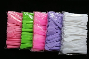 Macro detail of multicolored 13cm plastic cosmetic spatulas for facial mask mixing