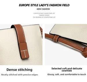 Close-up of premium pebbled leather grain with neat stitching on a beige shoulder bag