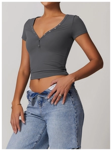 Close-up of slim fit dark grey yoga crop top with metal button V-neck detailing