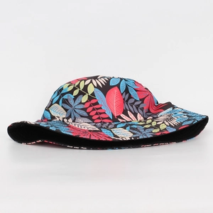 Detail of tropical plant leaf pattern on a black outdoor sun bucket hat