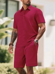 Men's burgundy waffle knit polo and shorts set featuring a textured pattern in outdoor setting