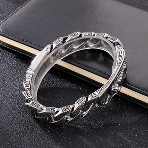 Detail of vintage silver titanium steel bracelet with engraved meander patterns