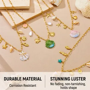 Detail of gold stainless steel ocean necklaces with shell, turtle and starfish charms