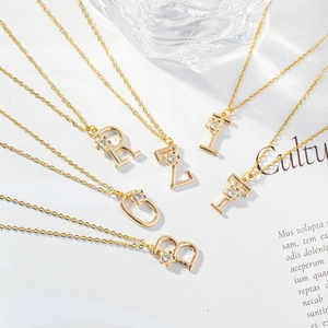 Gold letter necklace with micro-paved zircon flower pendant and fine cross chain link