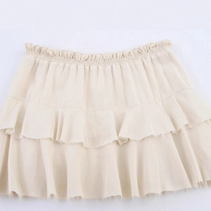 Apricot tiered mini skirt with ruffle layers in a lightweight textured chiffon fabric