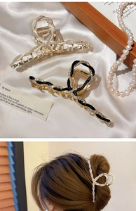 Detail showing elegant gold-finish floral hair claw with pearls and rhinestones