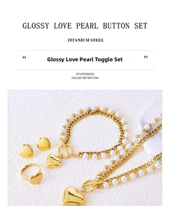 Detail of titanium steel jewelry set featuring heart charms and white pearls with toggle clasp