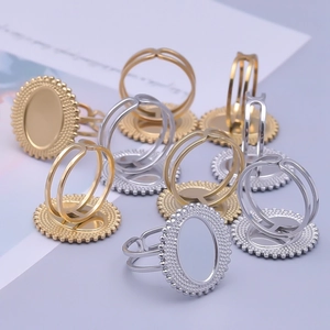 Detailed view of oval DIY ring bases in gold and silver with bead textured borders
