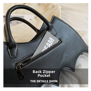 Detail view showing back zipper pocket of the black bat shaped fashion crossbody bag