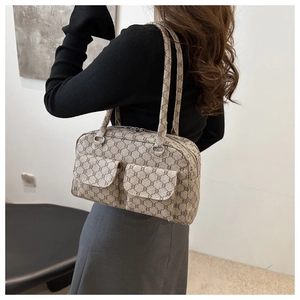 Detail of Boston-style underarm bag featuring classic monogram canvas and dual front flap pockets