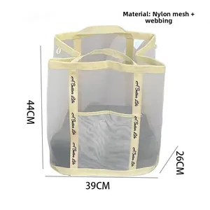 Detail view of cream mesh storage bag with dimensions 44cm x 39cm x 26cm and nylon strap