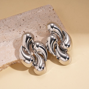 Detailed view of silver liquid drop earrings with a high-polish metallic finish