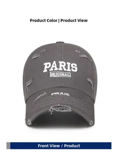 Detail of distressed dark grey baseball cap with white Paris embroidery and ripped edges