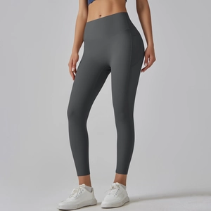 Detailed close-up of high-waisted seamless yoga pants in dark gray with sculpting seams