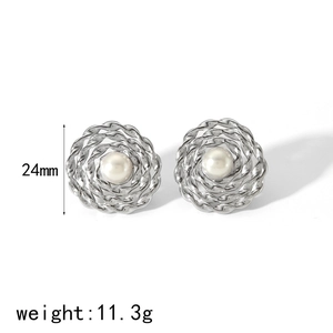 Detailed view of 24mm silver hollow earrings with woven texture and white pearl center