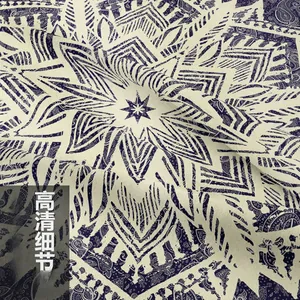Close-up of navy and cream mandala paisley fabric texture with soft drape folds