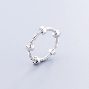 Macro detail of silver nut and bolt ring showing polished metallic texture and engraving