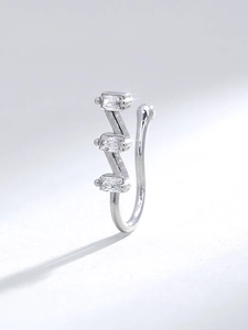 Detail of silver U-shaped nose ring with three sparkling square zircon stones inlay