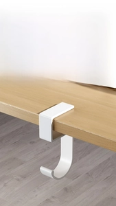 Detail of white J-shaped metal desk hook featuring punch-free clip-on installation