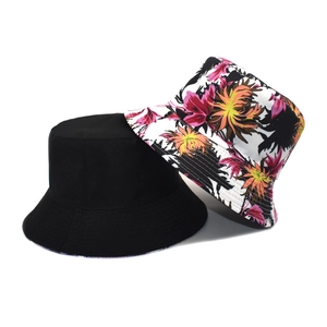Detail of reversible bucket hat showing solid black and colorful floral print sides