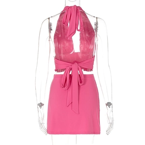 Detail of rose pink two-piece set featuring a halter tie-back top and mini skirt