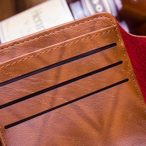 Close-up of brown litchi leather wallet with neat stitching and multiple card slots