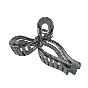 Detail of black translucent bow hair claw clip showing durable inner metal spring