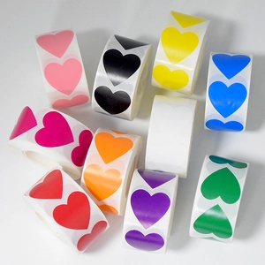 Detailed view of colorful heart-shaped stickers in multiple rolls on a white background
