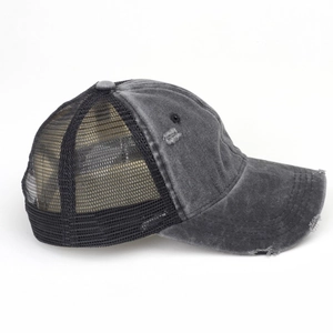 Side view of gray washed distressed baseball cap with black mesh back and worn details