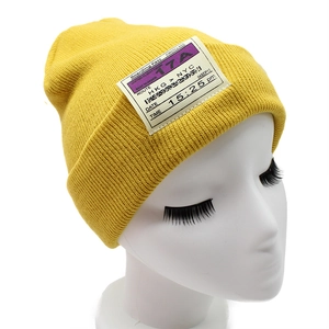 Winter yellow ribbed knit beanie featuring a unique boarding pass patch design