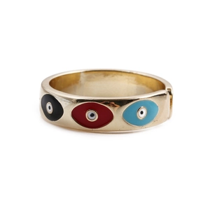 Detailed view of gold plated adjustable ring featuring colorful evil eye enamel patterns
