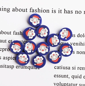 Detailed view of round blue Santa Claus polymer clay beads for DIY jewelry making