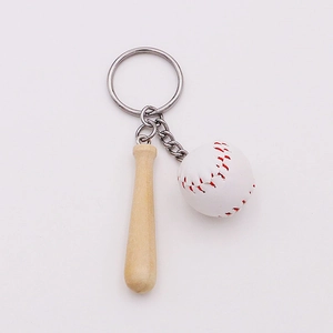 Detailed close-up of a mini wooden baseball bat and white ball keychain with metal ring