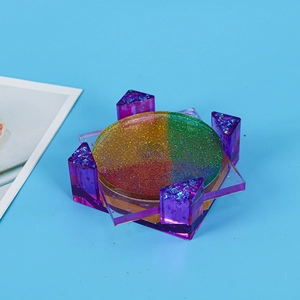 Detailed top view of a handmade floral resin coaster with colorful glitter gradient finish