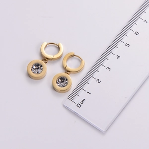 Macro detail of 14K gold titanium hoop earring with large crystal and Roman numerals