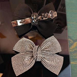 Detail view showing metal spring clip back and rhinestone bow hair clip structure