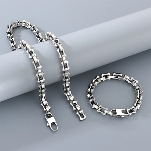 Close-up of silver stainless steel bamboo chain necklace and bracelet with lobster clasp