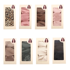 Set of eight satin hair scrunchies in various colors packaged in elegant display boxes