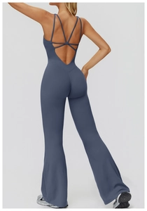 Detail of cross-back straps and flared legs on a dark grey-blue yoga jumpsuit