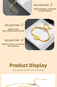Detail of gold four-leaf clover charm on flat snake chain with durable lobster clasp